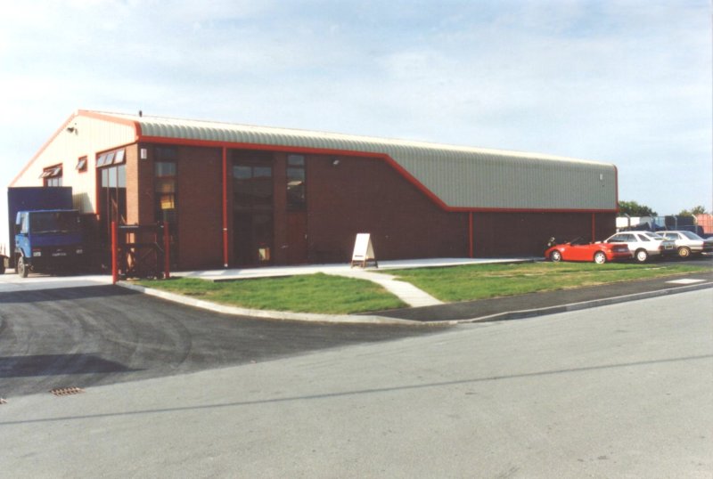 Curved_Eave_and_Red_Sheeting_Steel_Building_Industrial_Factory_Custom_Precision_UK_03
