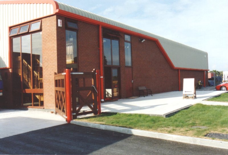 Curved_Eave_and_Red_Sheeting_Steel_Building_Industrial_Factory_Custom_Precision_UK_04